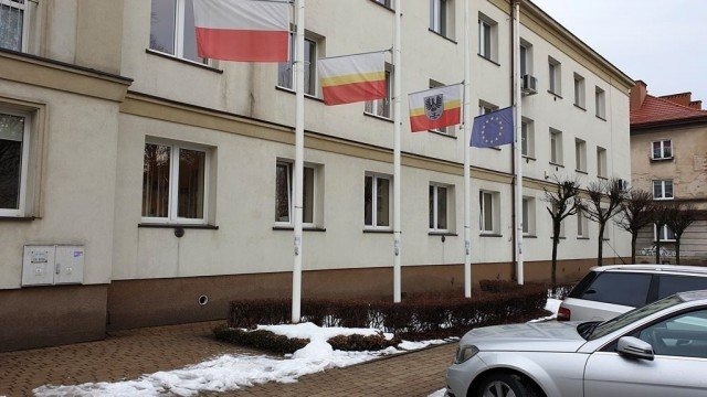 Flagi przed starostwem opuszczone do połowy masztów